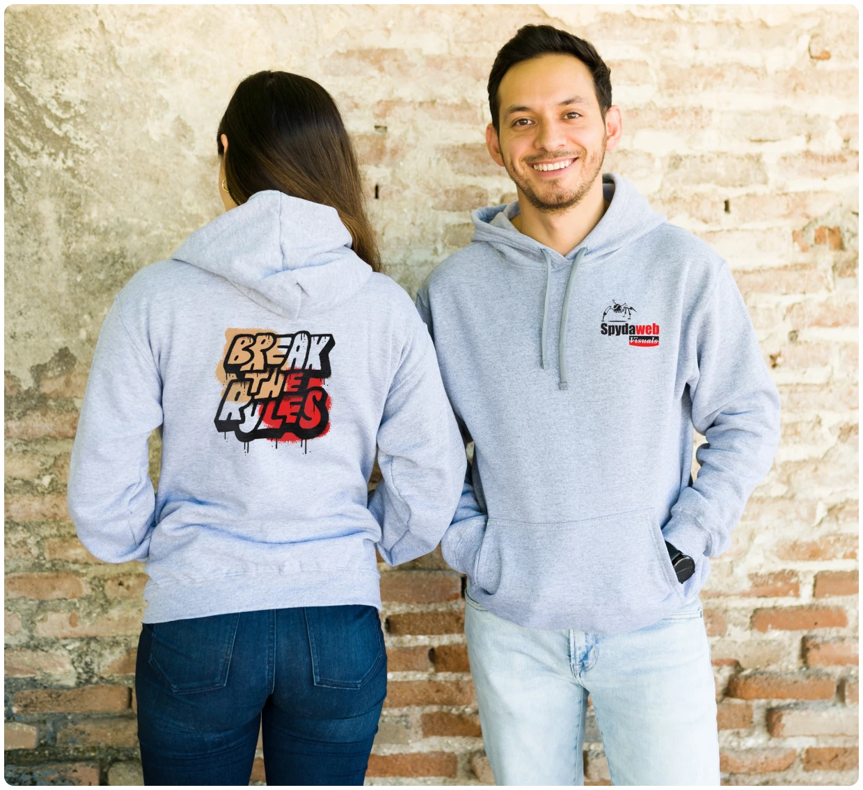 Two people wearing graphic hoodies