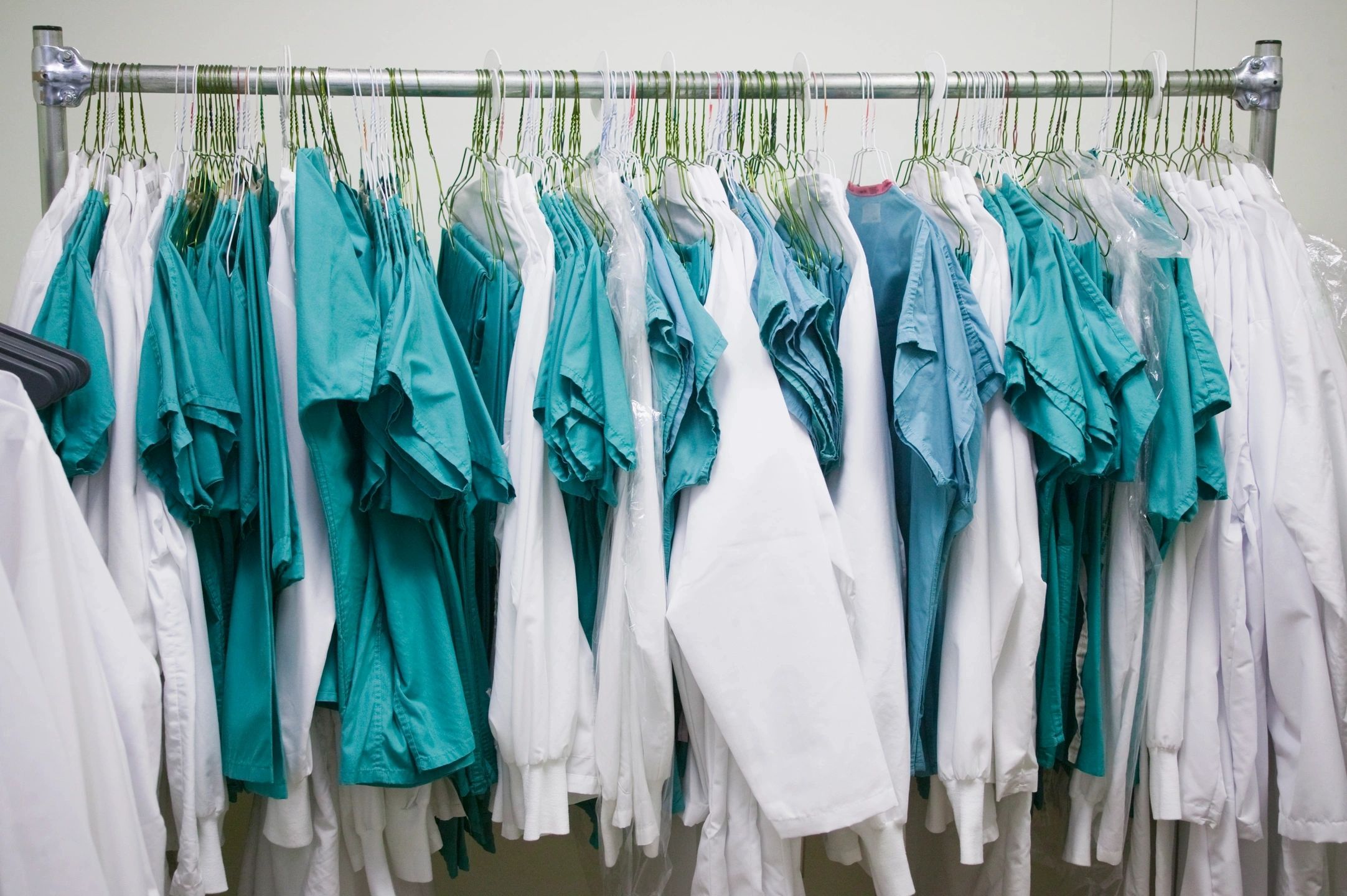 Medical uniforms on a clothing rack